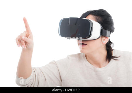 Female getting experience using VR headset and pointing on empty screen on white background Stock Photo