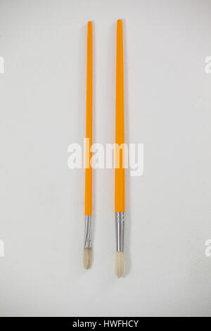 Close-up of paint brushes against white background Stock Photo
