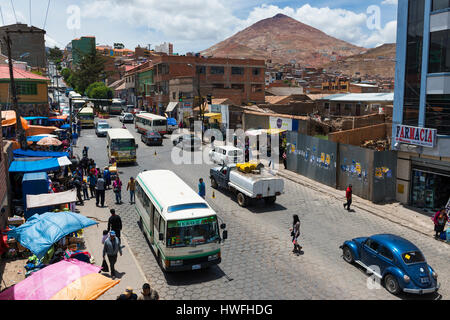 Potosi, Bolivia - November 30, 2013: View of a busy street in the city of Potosi with the Cerro Rico on the background. Stock Photo