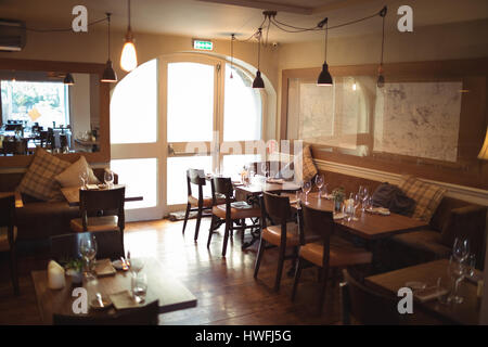 Tables and chairs arranged in empty modern coffee shop Stock Photo