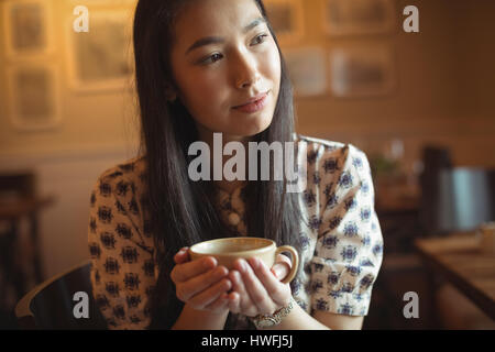 Thoughtful woman having cup of coffee at cafÃƒÂ© Stock Photo