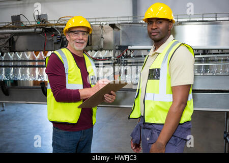 Portrait of male workers standing in juice factory Stock Photo