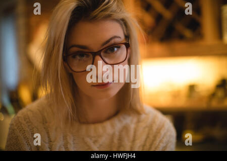 Portrait of thoughtful woman in kitchen at home Stock Photo