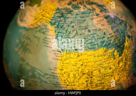 close up of old fashioned world globe a ball shaped map lit from within focusing on new zealand Stock Photo