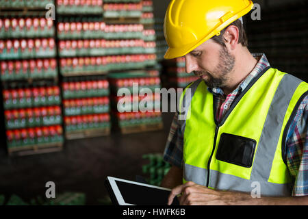 Young man using digital tablet in warehouse Stock Photo
