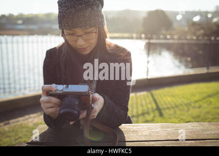 Woman looking at photos on digital camera on a sunny day Stock Photo
