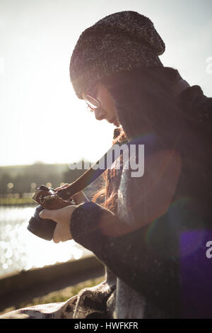 Woman looking at photos on digital camera on a sunny day Stock Photo