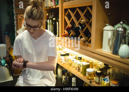 Woman using smart watch at home Stock Photo