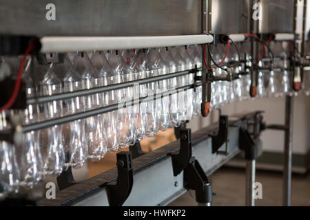 Row of empty bottles on production line in cold drink factory Stock Photo