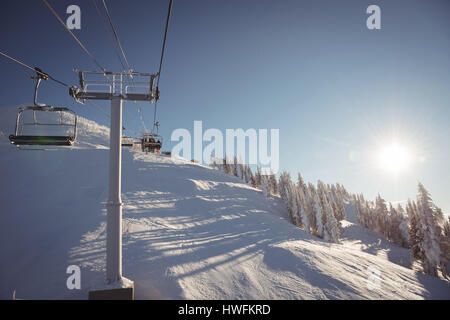 Empty ski lift in the ski resort against blue sky Stock Photo