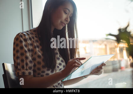 Beautiful woman using futuristic digital tablet at cafÃƒÂ© Stock Photo