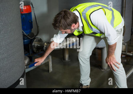 High angle view of male worker operating machinery in factory Stock Photo