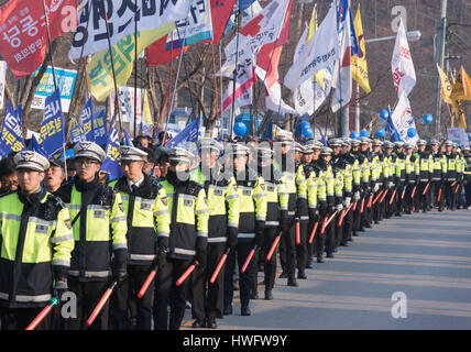 U.S. THAAD in South Korea, Mar 18, 2017 : Policemen walk along as residents and peace activists march toward a Lotte golf course during a rally against a plan of the U.S. and South Korea to deploy a Terminal High Altitude Area Defense (THAAD) battery in Seongju, about 260 km southeast of Seoul, South Korea. The U.S. and South Korea had agreed to station the anti-missile battery with a high-powered radar on a Lotte golf course in Seongju to counter missile threats from North Korea but China opposed the deployment as they asserted the United States will spy on Chinese military with THAAD. China Stock Photo