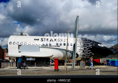 Bolton, UK. 21st Mar, 2017. A unique new restaurant in a former Russian jet has just 'landed' in Bolton. The Steak Out, Steaks on a Plane diner, built inside a Boeing 737 aircraft on Deane Road in the town, offers diners a custom built interior featuring led lights to replicate the night sky plus murals of cities around the world. Foodies can also fasten their seat belts in the cockpit as they await their orders. The plane parked on its 'runway'. Picture by Paul Heyes, Tuesday March 21, 2017. Credit: Paul Heyes/Alamy Live News Stock Photo