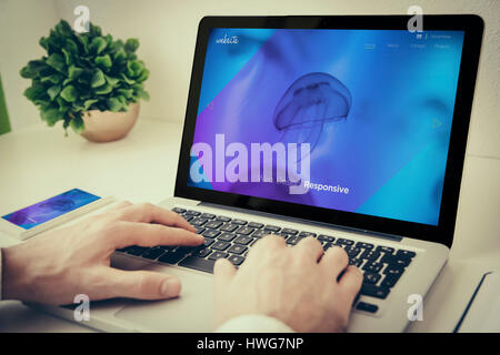 Hands using laptop on desktop with series streaming Stock Photo
