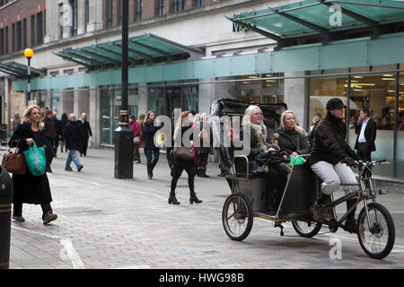 LONDON, UK - APRIL 22, 2016: Tourists riding in a Rickshaw Central London Stock Photo