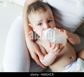 mother with her one year old son drinking water out of the bottle Stock Photo