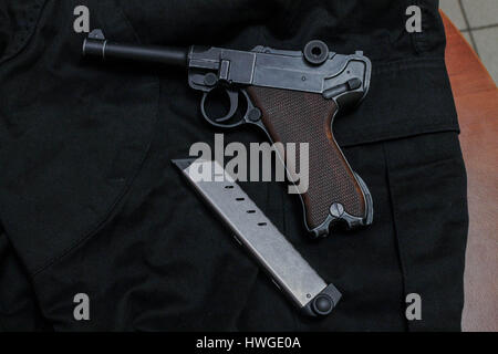 Nagan pistol with magazine for ammunition. Black revolver. Stock Photo