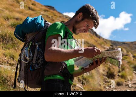Italy, Valle d'Aosta, Aosta, Pila, Hiker observing a map in the Arbolle valley Stock Photo