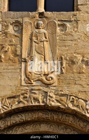 Italy, Lombardy, Pavia, Basilica di San Michele Maggiore, Saint Michel trampling a dragon above the central gate Stock Photo