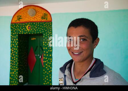 Tunisia, Ksour Area, Matmata, young Tunisian boy by mosque entrance Stock Photo