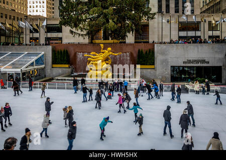 People ice skating in front of Rockefeller Center Christmas Tree - New York, USA Stock Photo