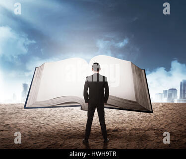 Young business man reading big book. Business education concept Stock Photo