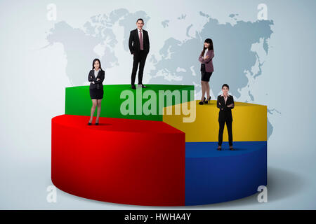 Asian Business Team Standing On Pie Chart Stock Photo