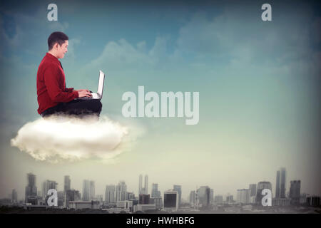 Business man working with laptop on the sky with city background Stock Photo