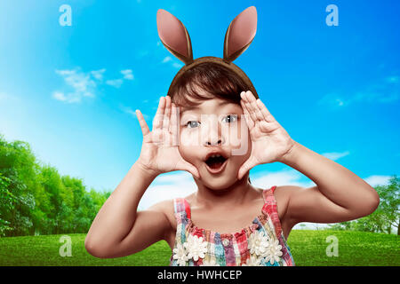 Cute little child girl wearing bunny ears on Easter day Stock Photo