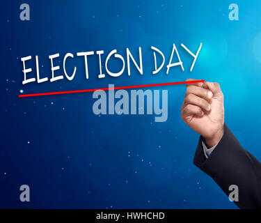 Man hand writing a 'ELECTION DAY' with gold marker on visual screen Stock Photo