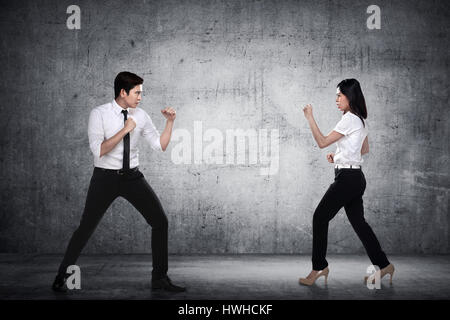 Business man and woman fighting. Working competition concept Stock Photo