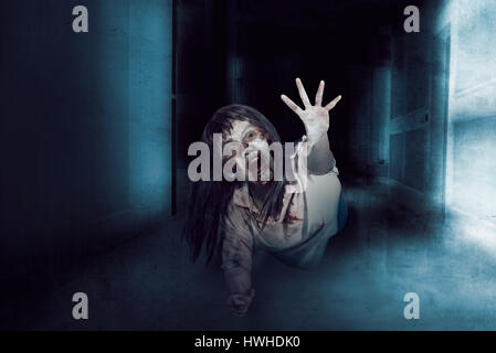 Asian zombie woman, ugly face and anger expression in empty room, horror situation. Stock Photo