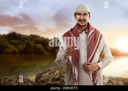 Image of muslim man smiling holding prayer beads Stock Photo