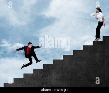 Asian business people using megaphone talk to the friend Stock Photo