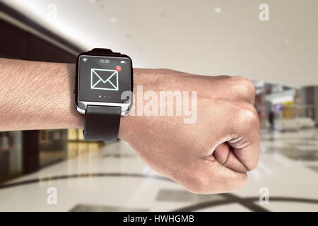 Close up smart watch with unread message icon on the screen is on hand Stock Photo