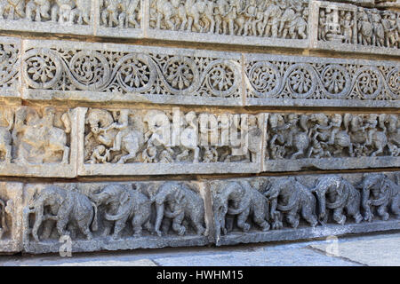 Ornamented stone panel, sculpted procession of elephants in the lowest molding, horsemen in the second and a band of foliage in the third, on Chennake Stock Photo