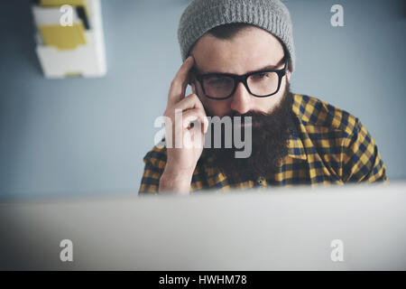 Pensive man working at home office Stock Photo