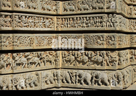 Shrine wall relief sculpture follows a stellate plan, makara(imaginary beast), Hindu puranas, foliage, horsemen and elephant procession, at the Chenna Stock Photo