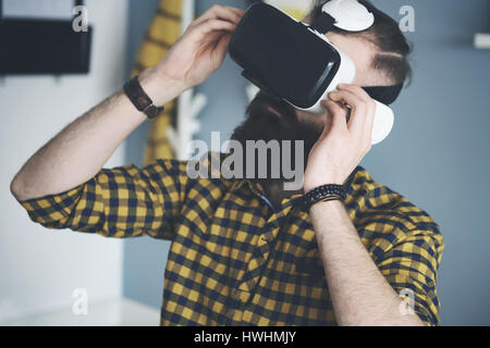 Bearded man using smart glasses Stock Photo