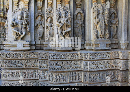 Ornamented detailed, stone carvings on Shrine wall. Relief sculpture depicting gods and goddess, swan, makara(imaginary beast), Hindu puranas, at the  Stock Photo