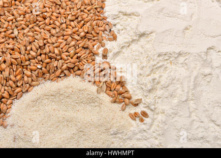 Grains wheat and flour on a wooden table. Concept of making food from cereals. Rustic background. Copy space Stock Photo