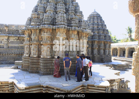 Tourists admiring the stone carvings at the main shrines at Chennakesava Temple, Hoysala Architecture, Somnathpur, Karnataka, India Stock Photo