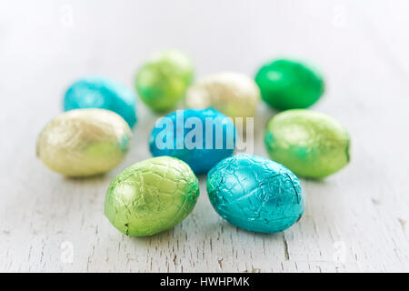 Close up of an assortment of chocolate Easter eggs on a rustic wooden background. Stock Photo