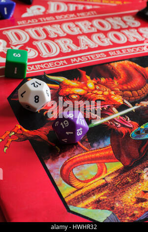 Vintage Dungeons and Dragons dungeon masters rule book published as part of a D&D game pack in 1983 with multi sided dice Stock Photo