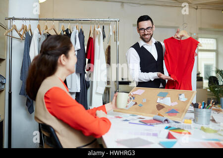 Two fashion designers discussing color and model of new stylish dress Stock Photo