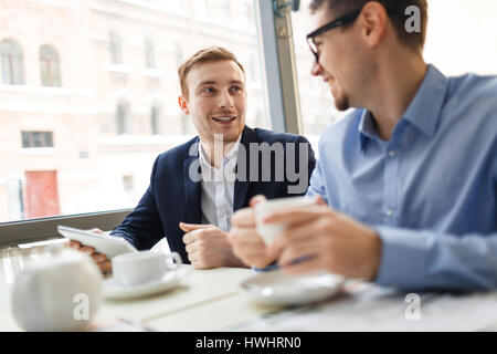 Modern bankers having discussion during business lunch Stock Photo