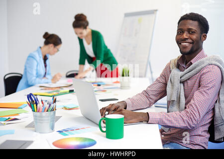 Young man browsing in the net in working environment Stock Photo
