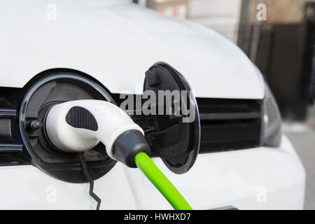 Close Up Of Electric Car Being Charged Stock Photo