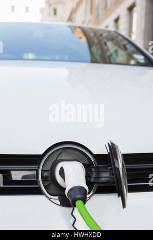 Close Up Of Electric Car Being Charged Stock Photo